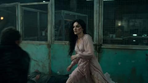 A cinematic, high-intensity fight sequence in a dark, gritty industrial warehous